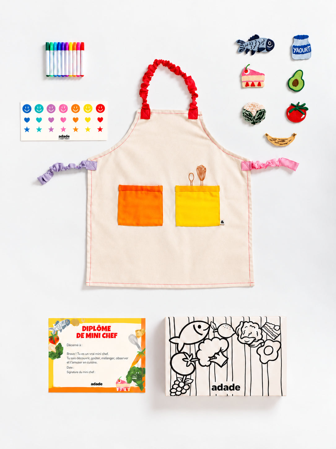 Box ADADE à colorier, décorée de rayures et d’illustrations de fruits et légumes en noir et blanc, pour une activité créative avec les enfants.