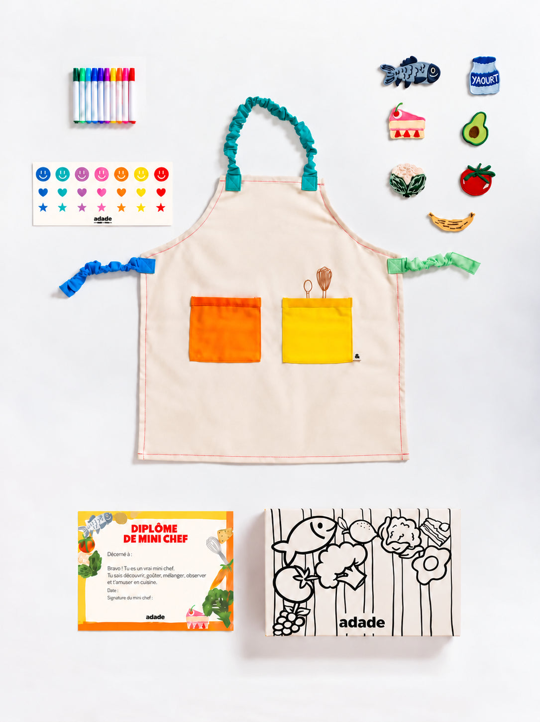 Box ADADE à colorier, décorée de rayures et d’illustrations de fruits et légumes en noir et blanc, pour une activité créative avec les enfants.