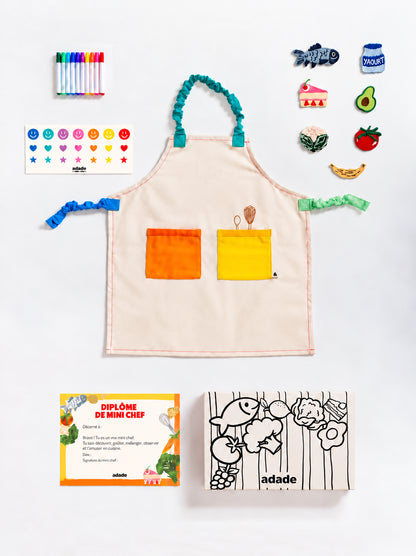 Box ADADE à colorier, décorée de rayures et d’illustrations de fruits et légumes en noir et blanc, pour une activité créative avec les enfants.